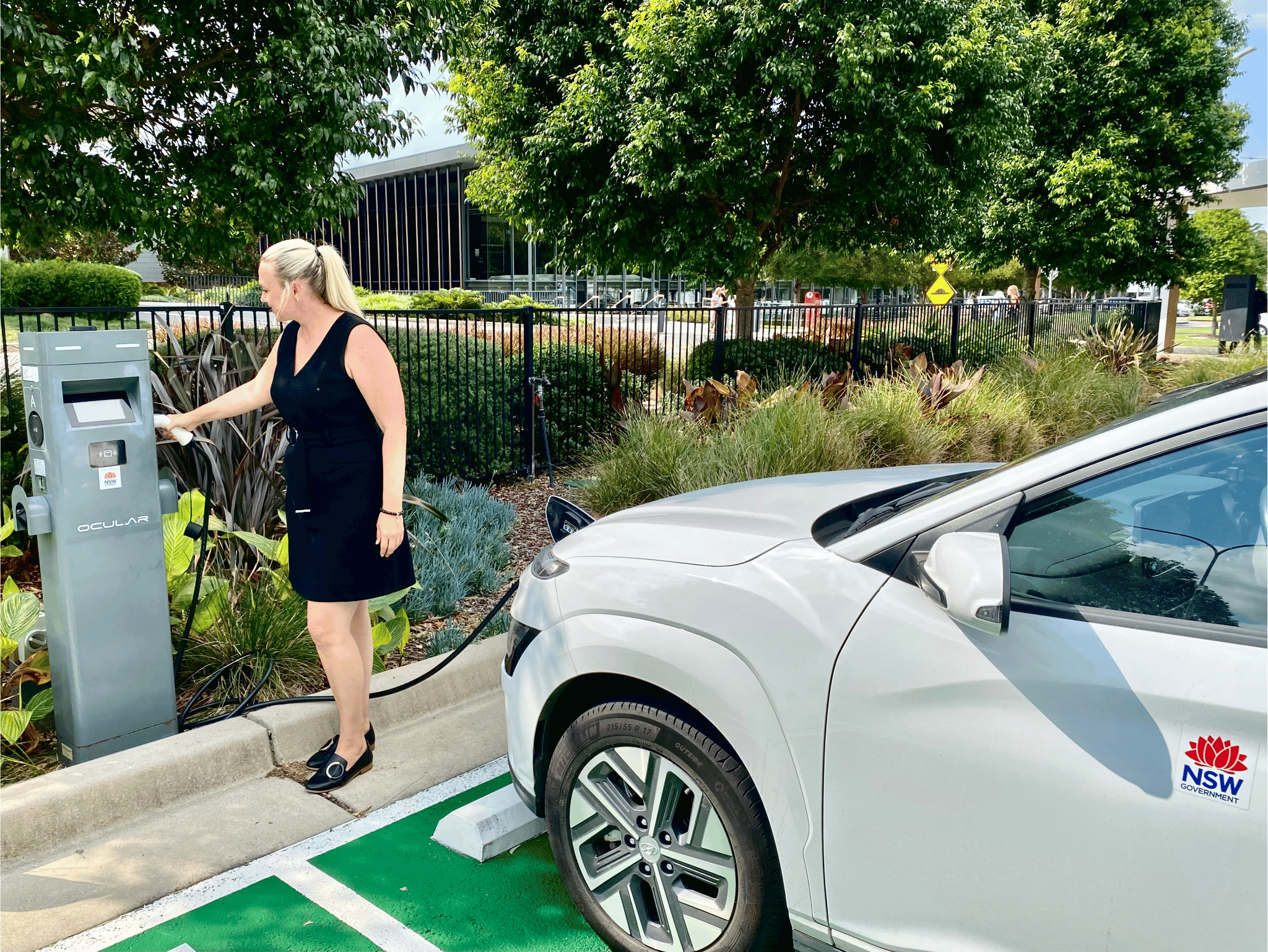 Woman charging her electric vehicle