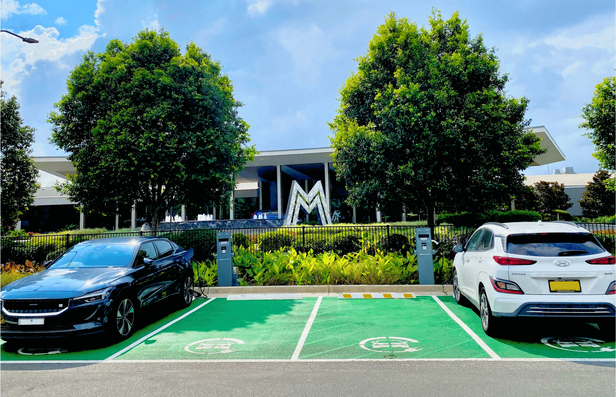 Electric vehicles parked in front of the Mingara Recreation Club
