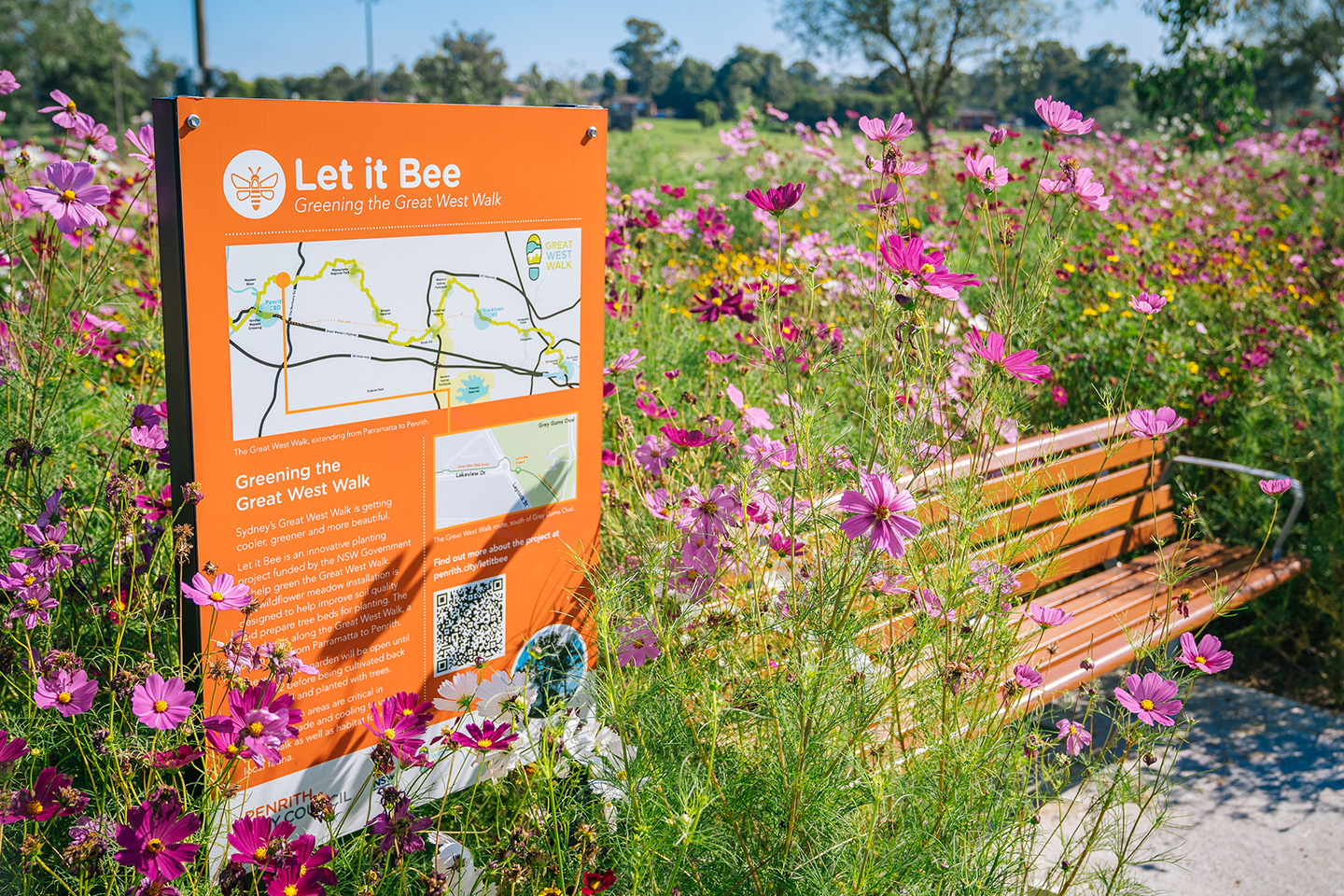 Sign, flowers and bench in Great West Walk