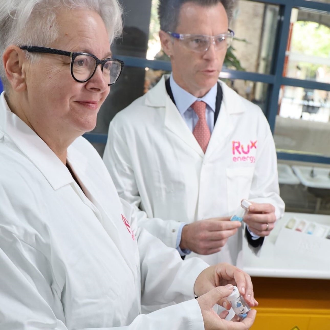 Premier and Minister in lab coats