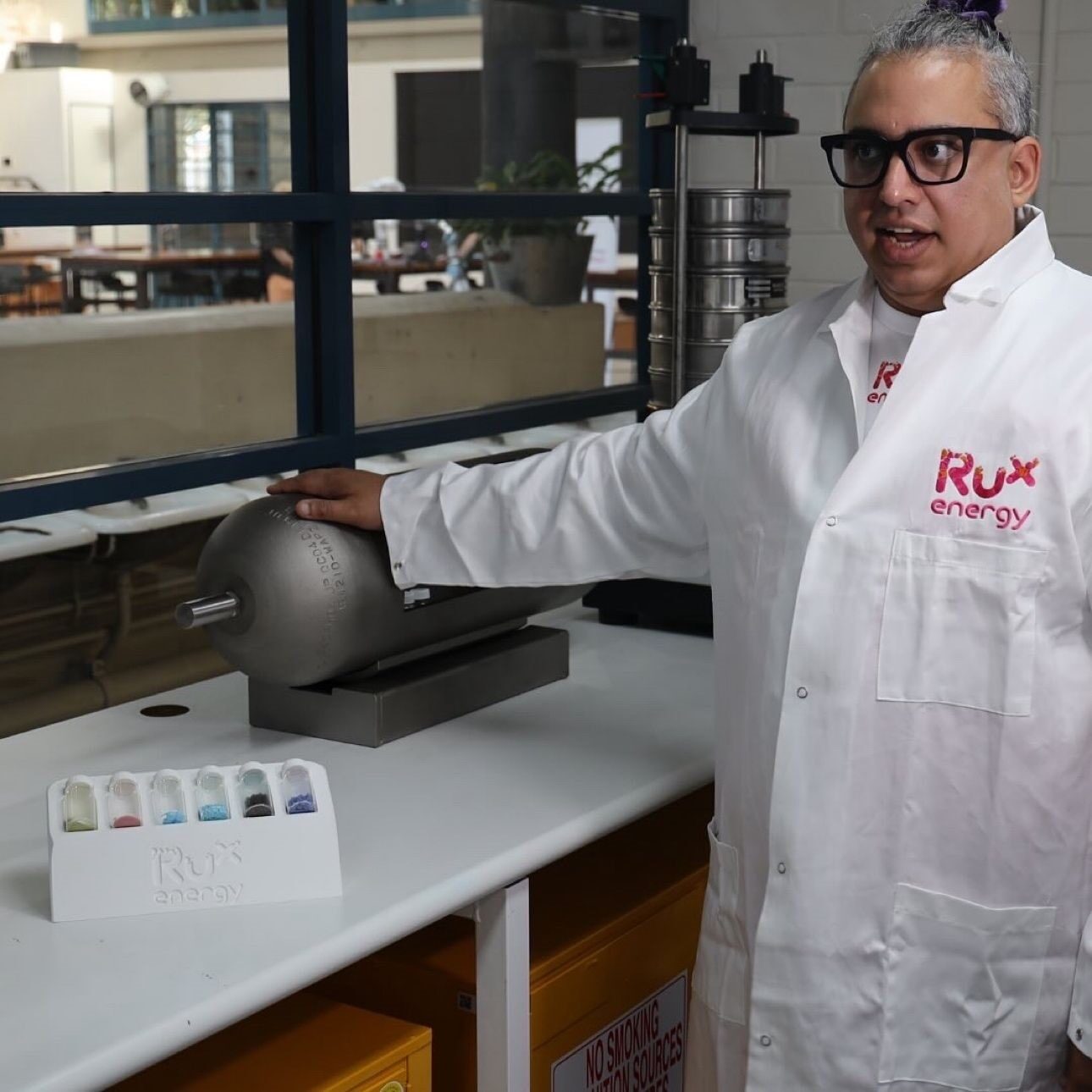 Person in lab coat with hydrogen equipment