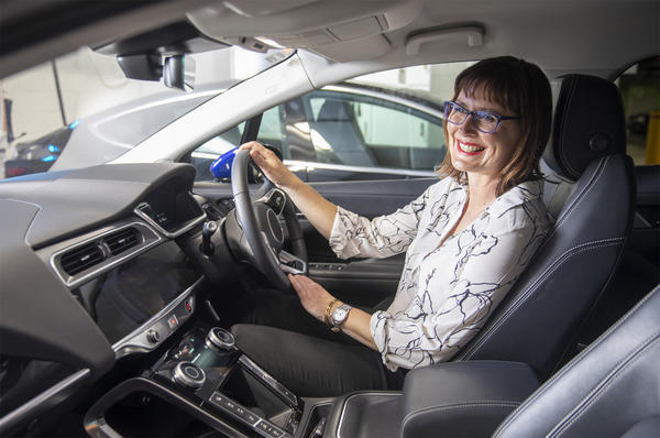 Woman smiling in electric vehicle
