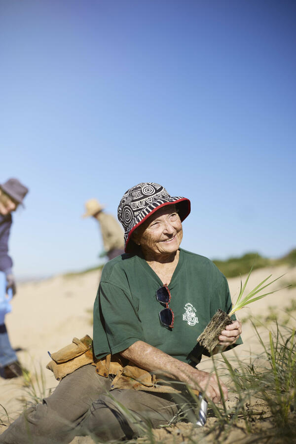 Older lady planting trees